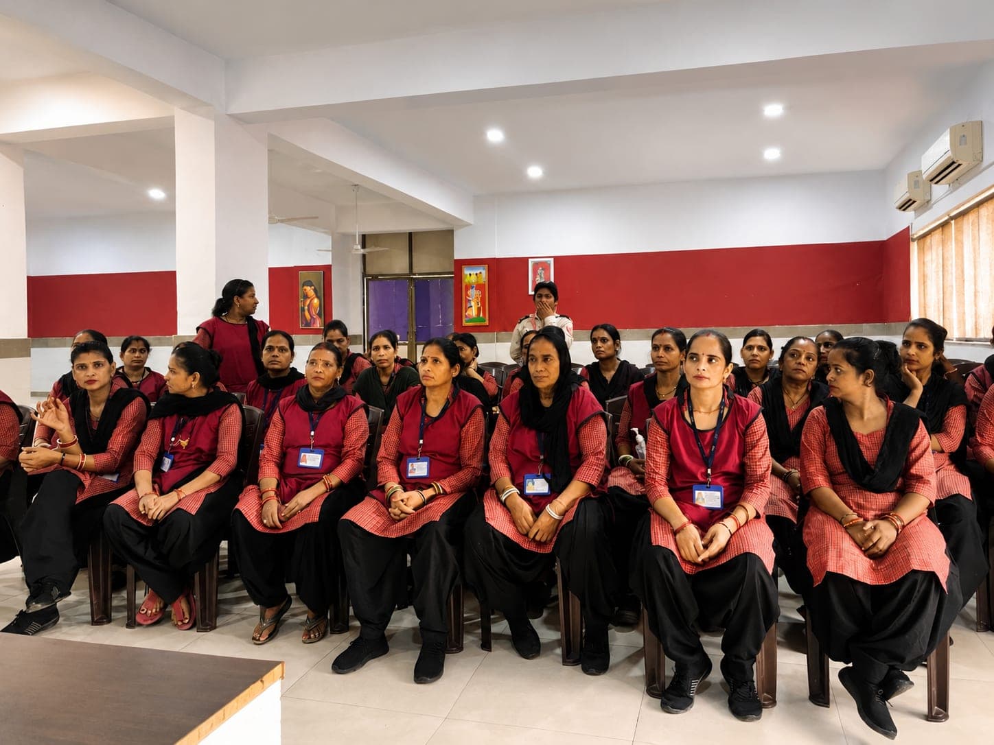 Uniformed MITRA staff attending a training session in a seminar hall